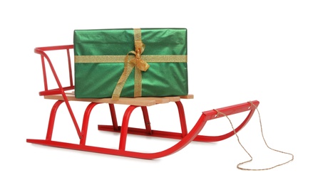 Sleigh with green gift box isolated on white