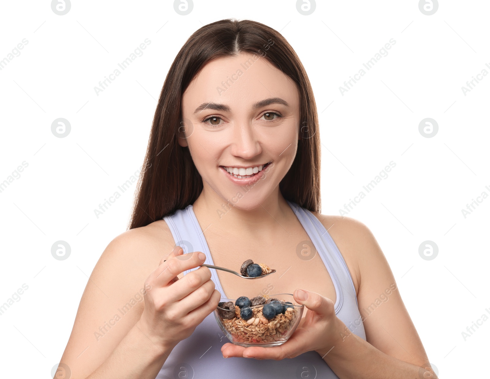 Photo of Happy woman eating tasty granola with fresh berries on white background