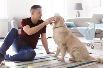 Portrait of owner with his friendly dog at home