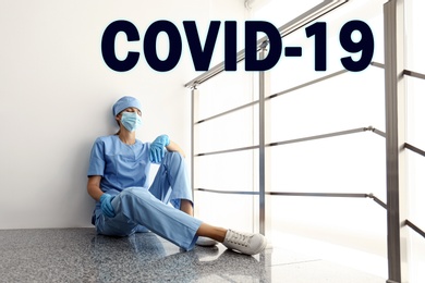 Tired overwhelmed nurse sitting on floor in hospital. Medical system collapse during coronavirus pandemic