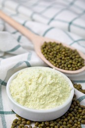 Photo of Bowl of flour and mung beans on cloth, closeup