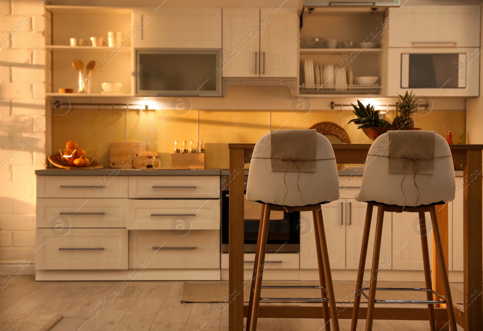 Photo of Modern kitchen interior with stylish wooden table. Space for text