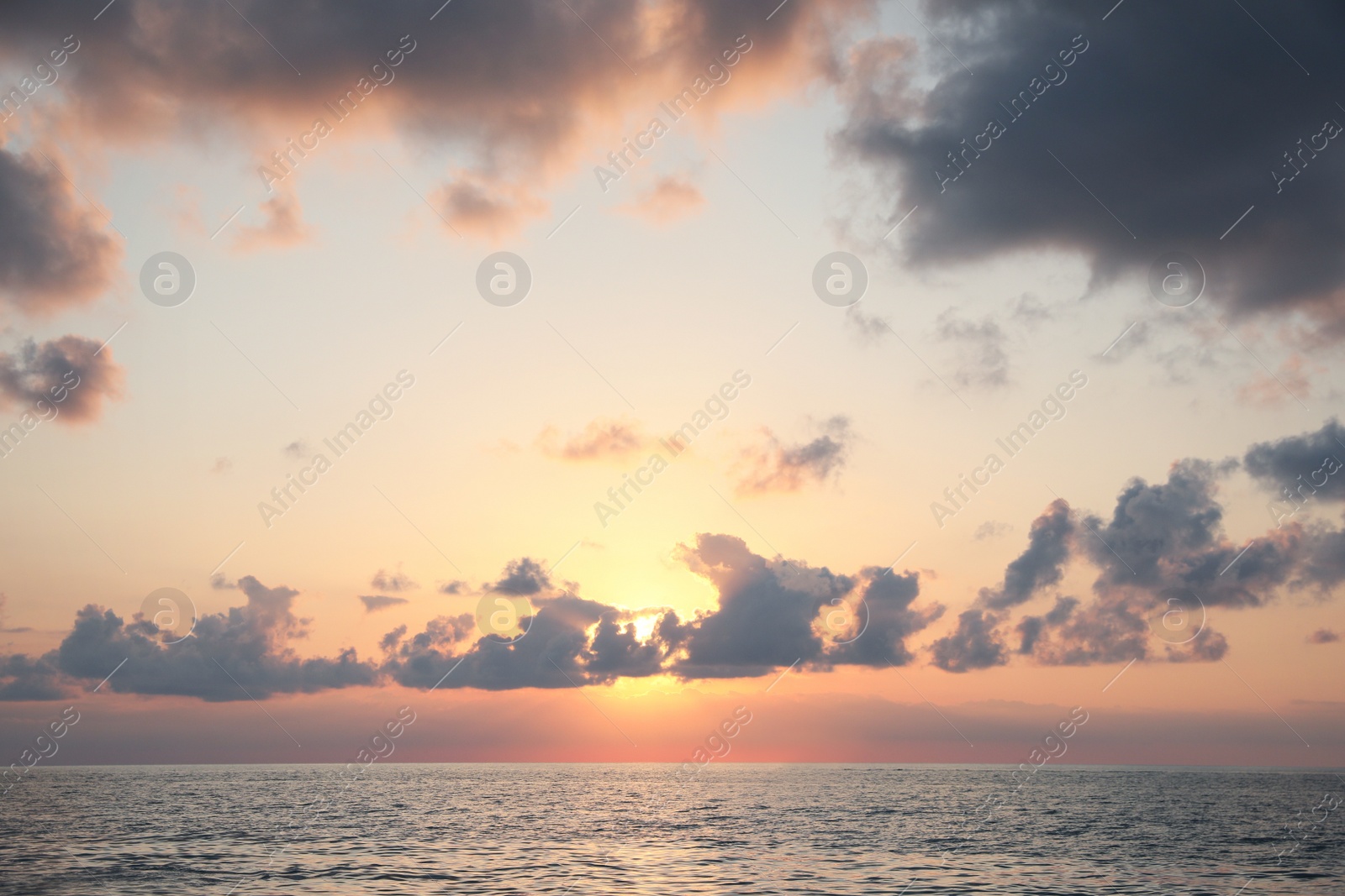 Photo of Picturesque view of beautiful sea and people parasailing at sunset