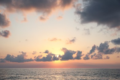 Photo of Picturesque view of beautiful sea and people parasailing at sunset