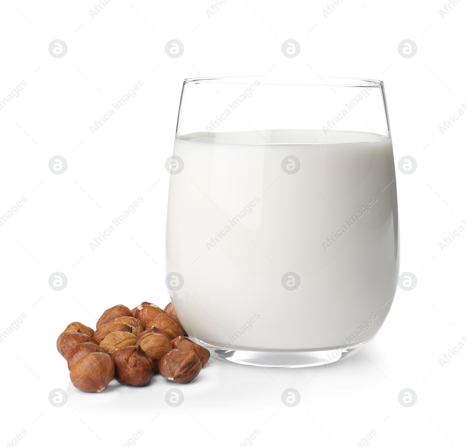 Photo of Glass with hazelnut milk on white background