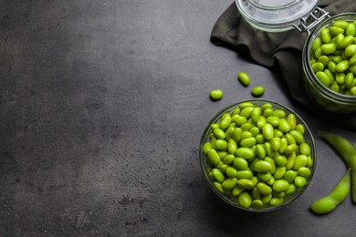 Photo of Organic edamame beans on grey table, flat lay. Space for text