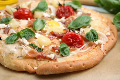 Photo of Delicious homemade pita pizza on parchment, closeup