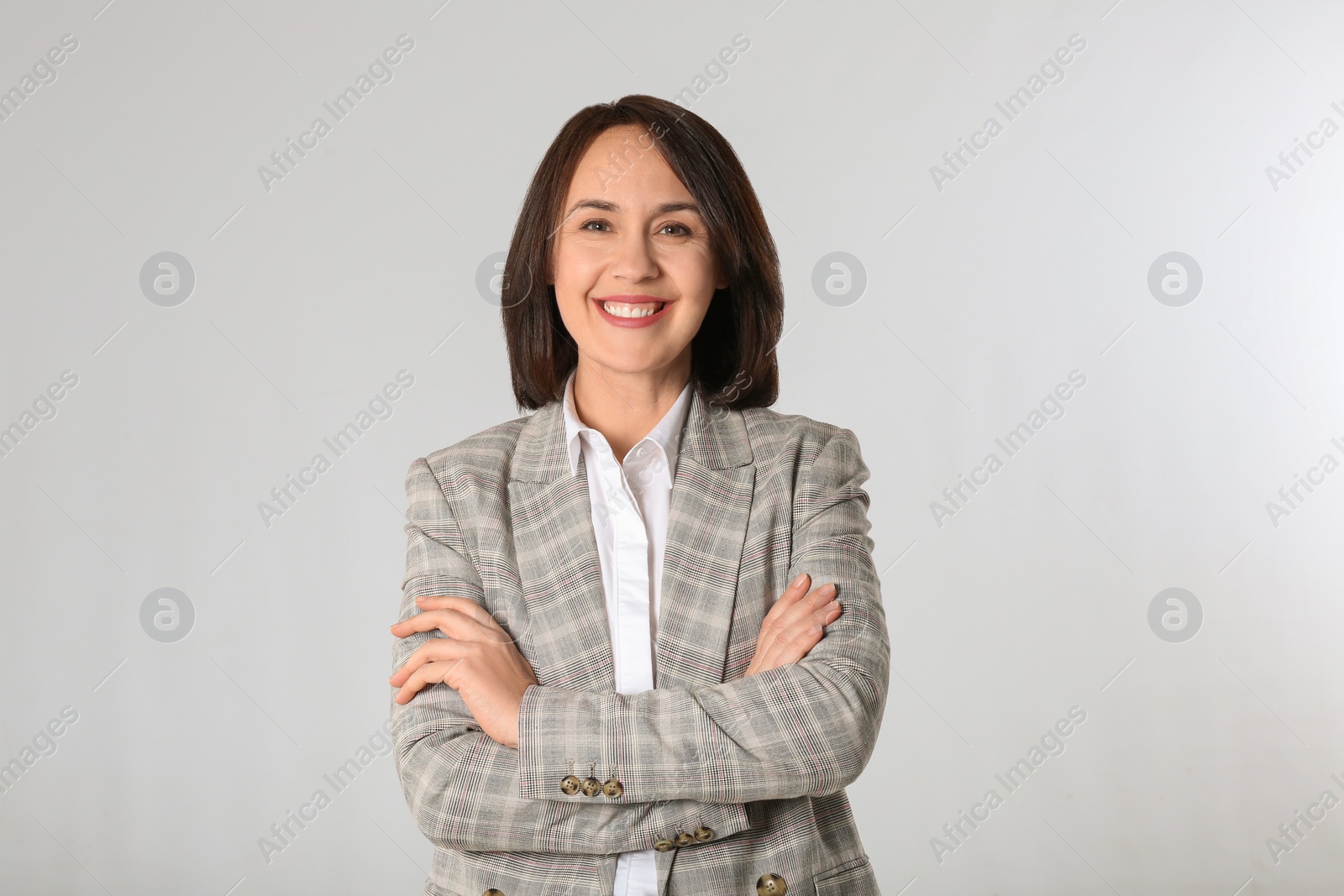 Photo of Portrait of mature businesswoman on light grey background