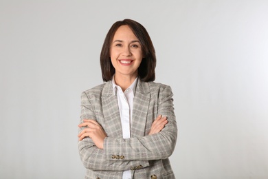 Portrait of mature businesswoman on light grey background