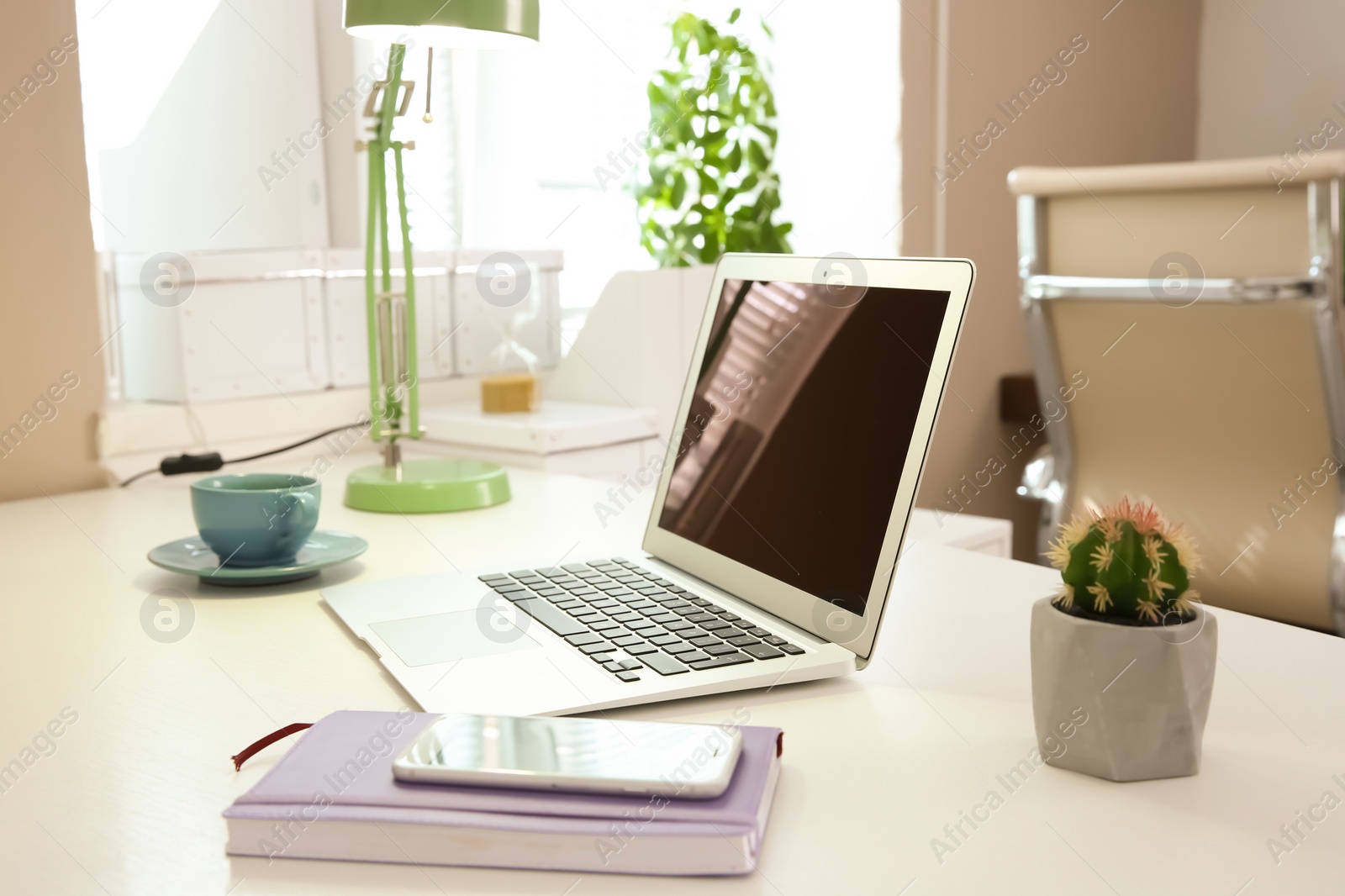 Photo of Stylish workplace with laptop on table