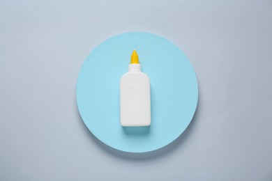 Photo of Bottle of glue on color background, top view