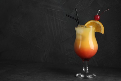 Photo of Just made appetizing cocktail Sex on the Beach, black background. Space for text