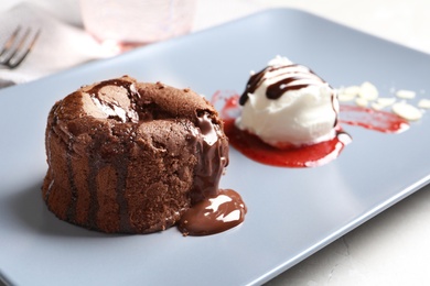 Photo of Delicious fresh fondant with hot chocolate and ice cream served on plate. Lava cake recipe