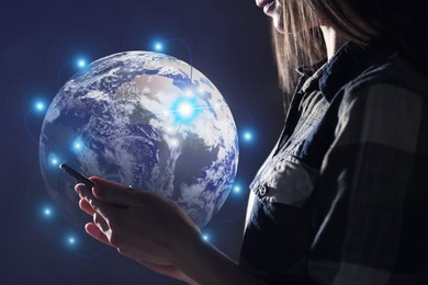 Image of Global network. Woman using smartphone on dark background, closeup. Digital image of Earth with connection lines