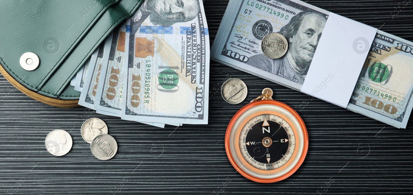 Image of Exchange rate. Wallet, money (dollar banknotes and coins) and compass on wooden background, flat lay. Banner design