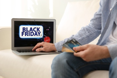 Photo of Man shopping online using laptop at home, closeup. Black Friday Sale