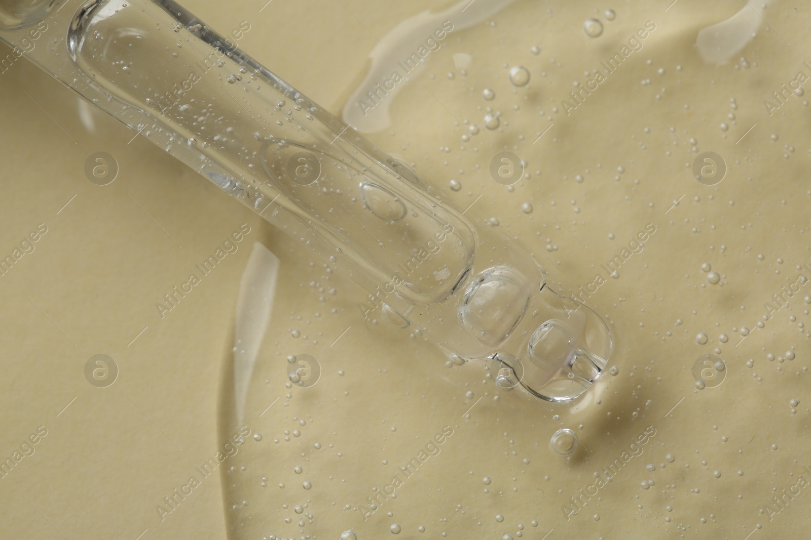 Photo of Pipette with cosmetic serum on beige background, above view