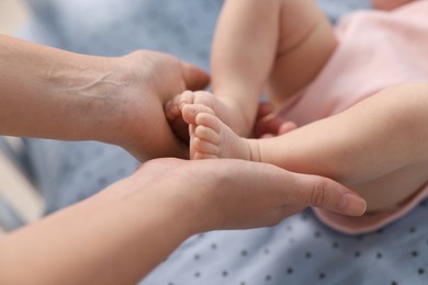 Photo of Mother with her cute little baby in crib, closeup