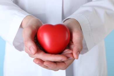 Doctor with red decorative heart, closeup view