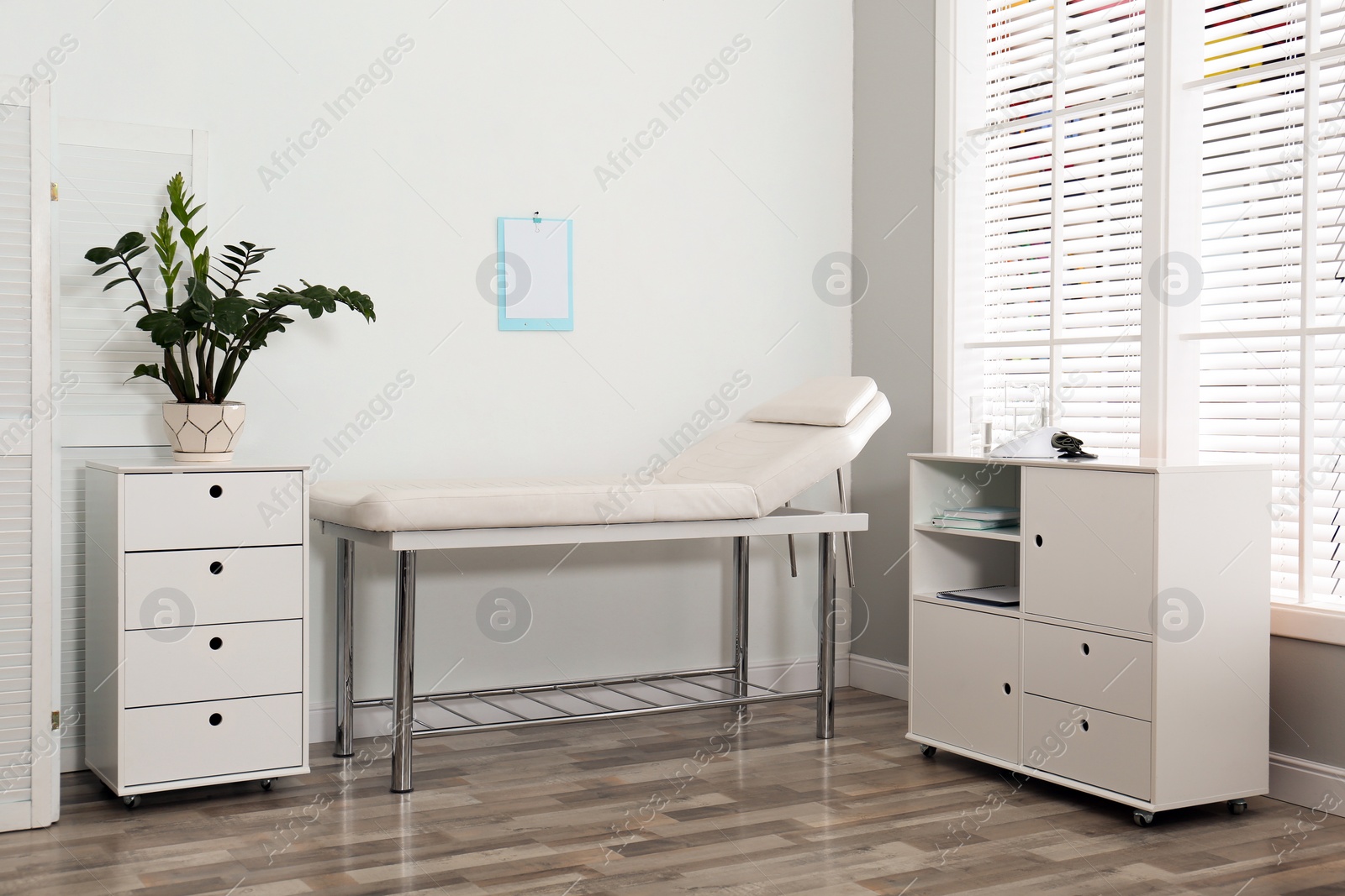 Photo of Modern medical office interior with examination table