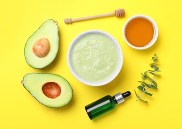 Homemade hair mask and ingredients on yellow background, flat lay