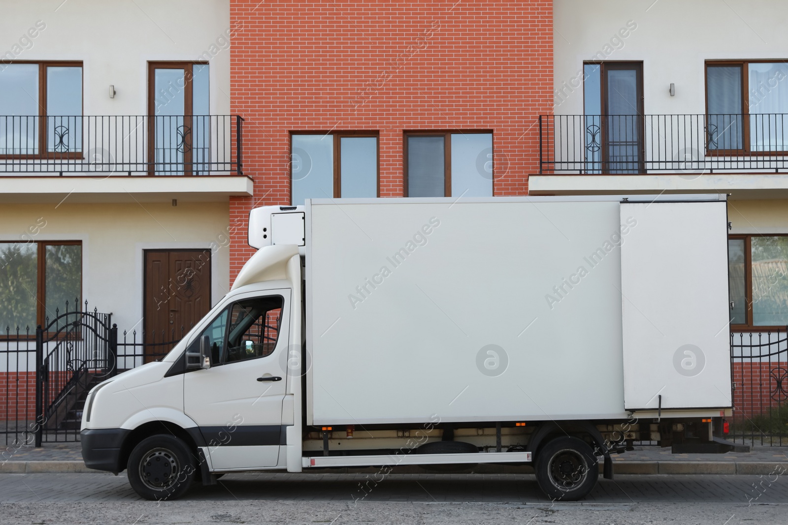 Photo of White van near new house. Moving service