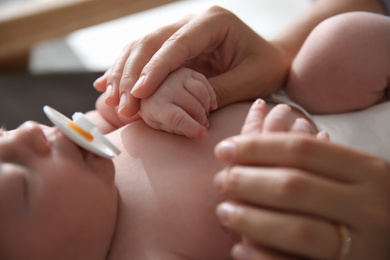 Mother with her newborn baby, closeup view