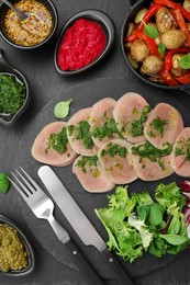 Photo of Tasty beef tongue pieces and ingredients served on grey table, flat lay