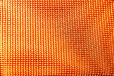 Textured orange fabric as background, closeup view