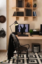 Photo of Stylish workplace interior with computer on table