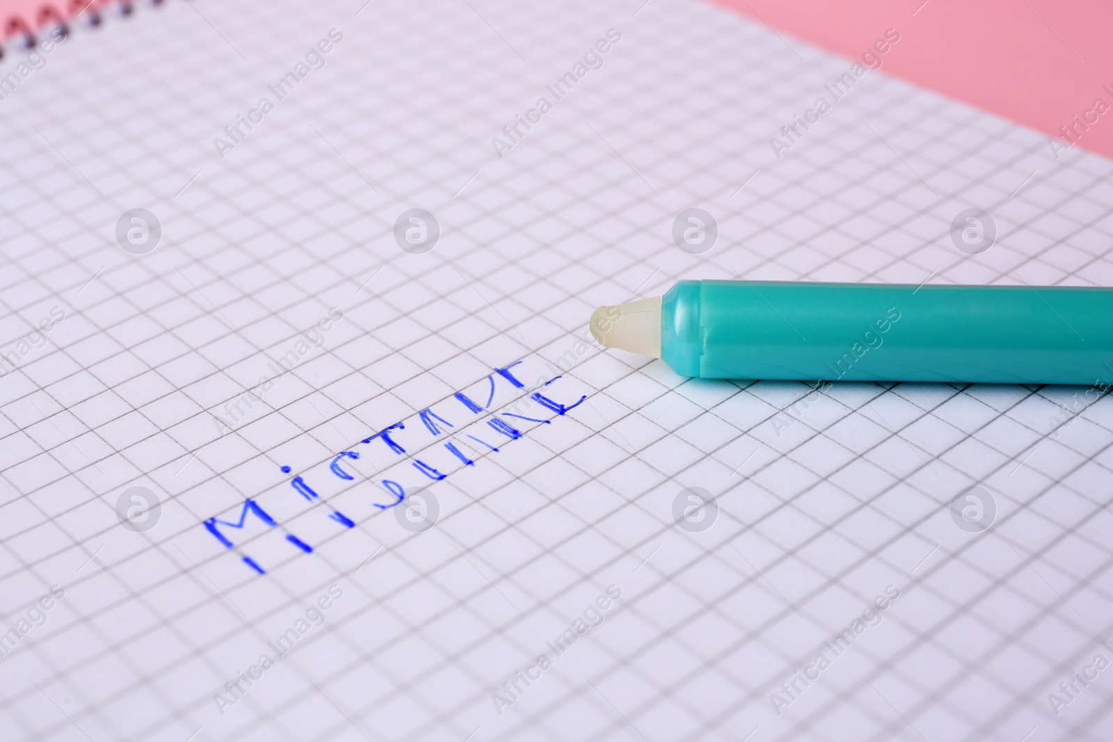 Photo of Word Mistake written on checkered paper with erasable pen, closeup