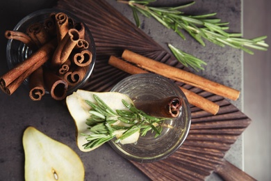 Photo of Flat lay composition rosemary and cinnamon cocktail on gray table