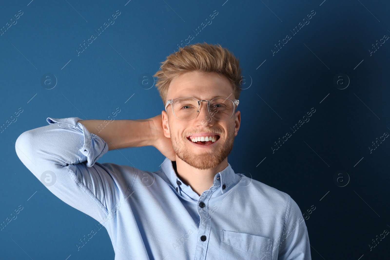 Photo of Portrait of handsome young man on blue background