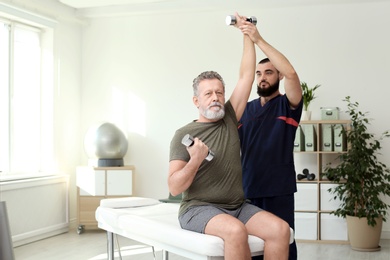 Physiotherapist working with patient in clinic. Rehabilitation therapy