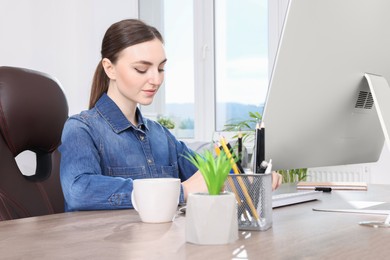 Young woman working at desk. Home office