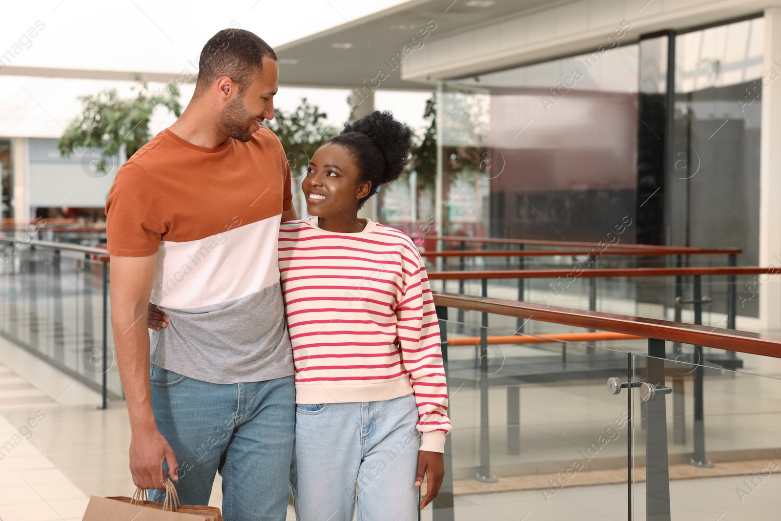 Photo of Family shopping. Happy couple with purchases in mall