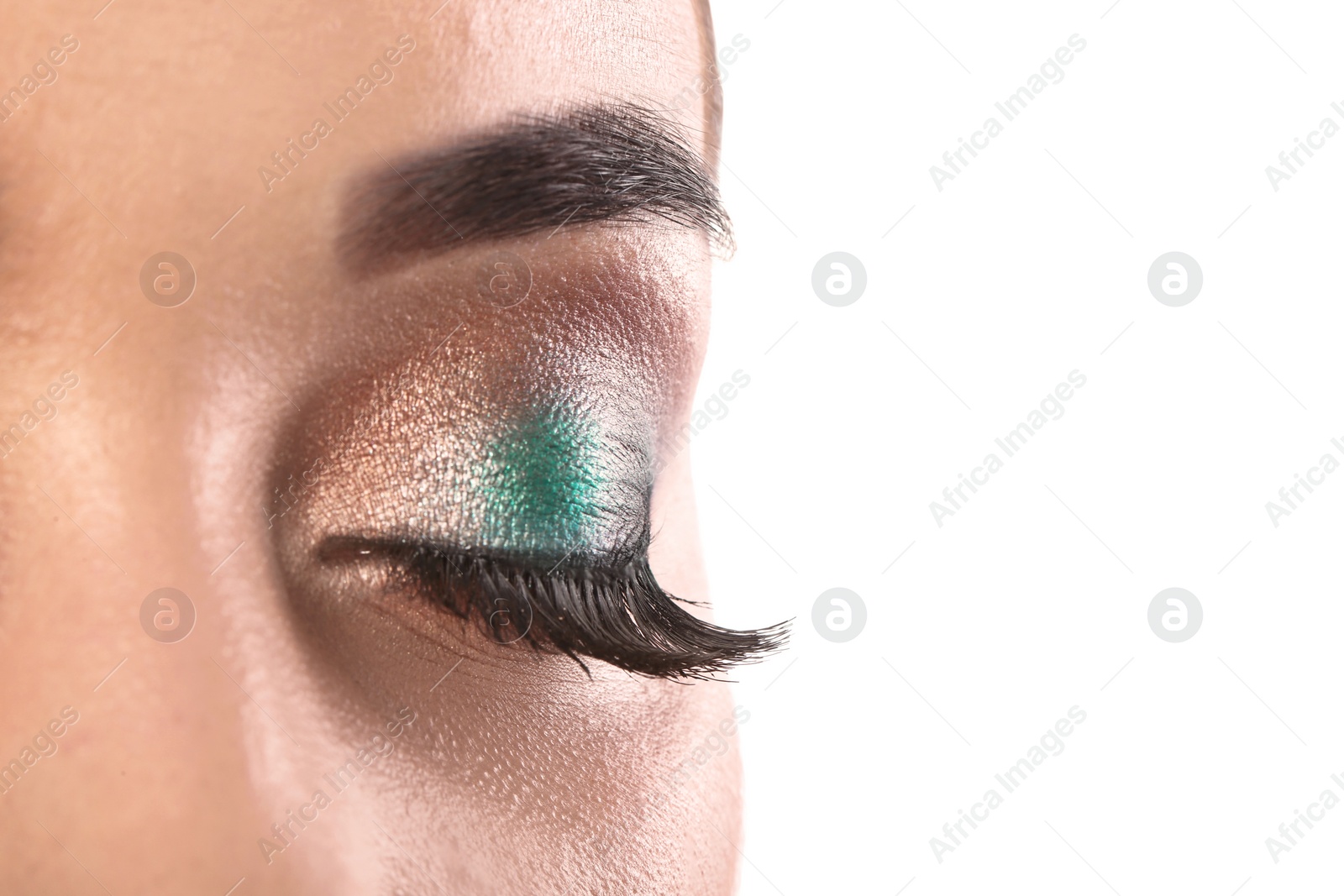Photo of Young woman with eyelash extensions and beautiful makeup on white background, closeup. Space for text