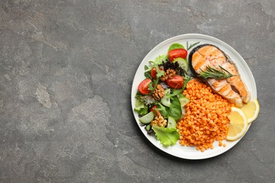 Photo of Plate with healthy food high in vegetable fats on grey textured table, top view. Space for text