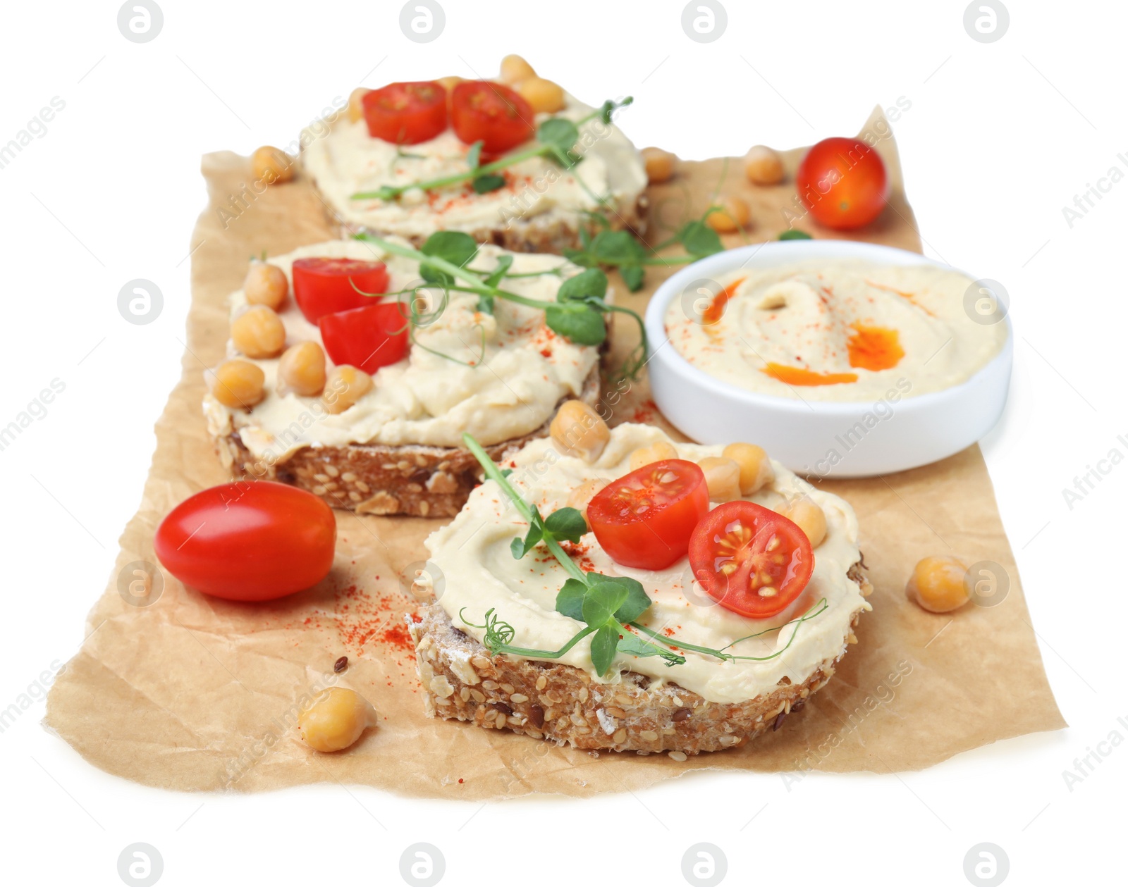 Photo of Delicious sandwiches with hummus and ingredients on white background