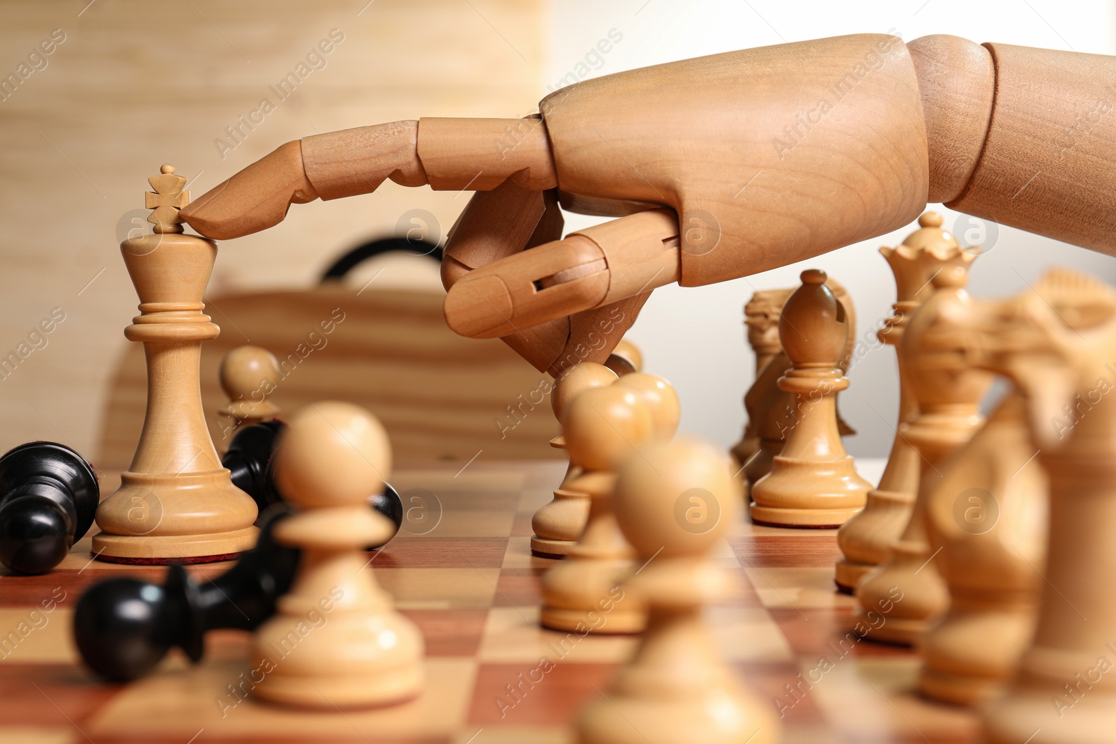 Photo of Robot moving chess piece on board, closeup. Wooden hand representing artificial intelligence