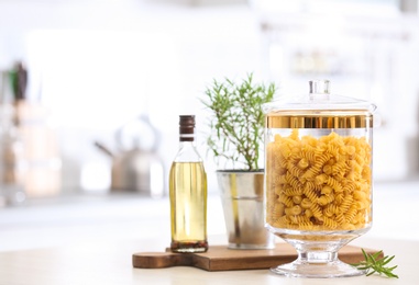 Raw pasta on wooden table in modern kitchen