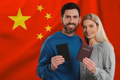 Image of Immigration. Happy couple with passports against national flag of China, space for text