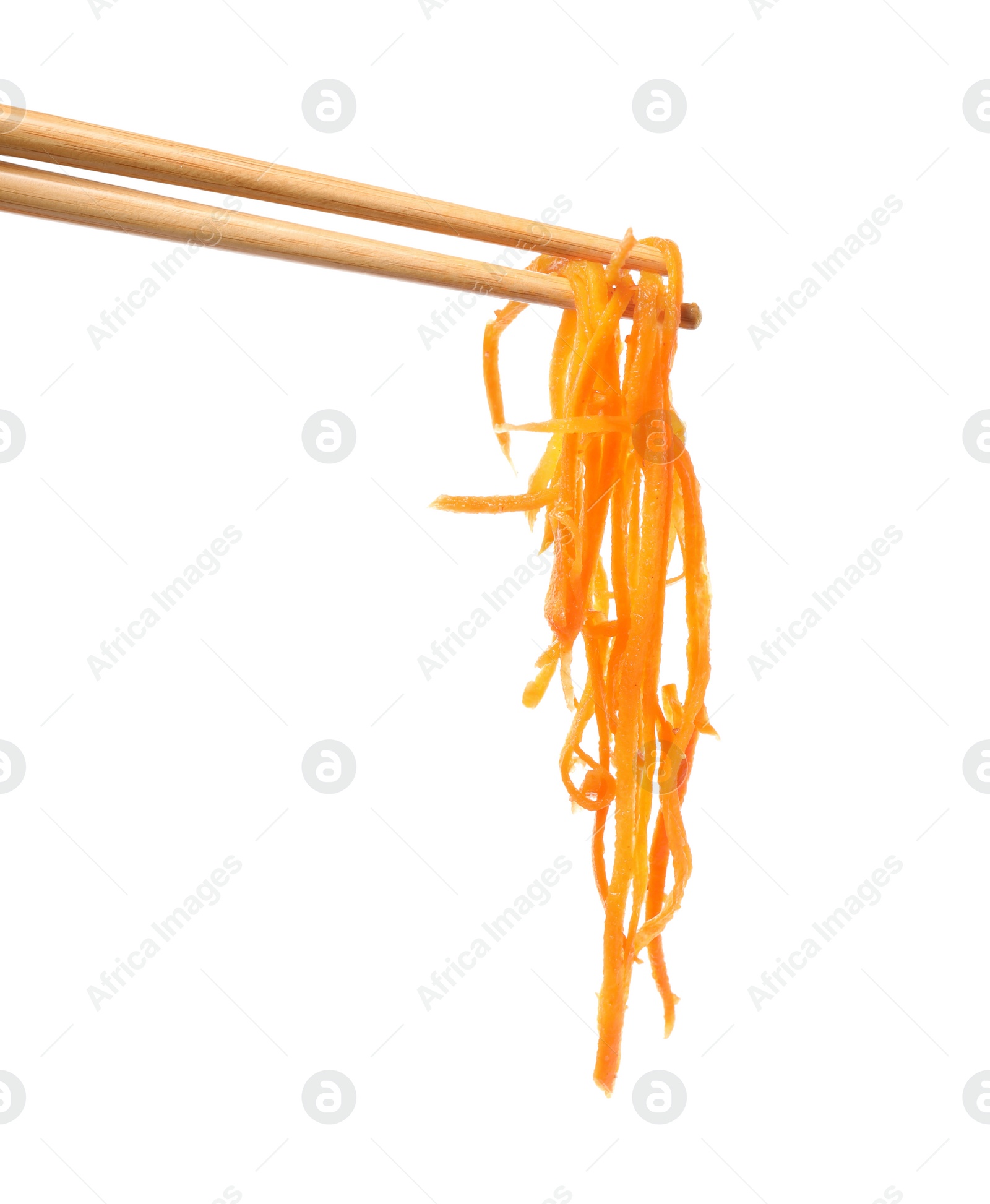 Photo of Chopsticks with delicious Korean carrot salad on white background