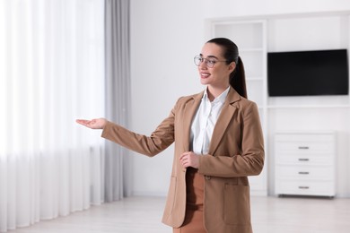 Photo of Happy real estate agent showing new apartment