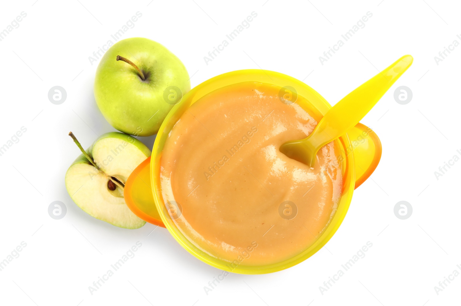 Photo of Bowl of healthy baby food and fresh apples on white background, top view