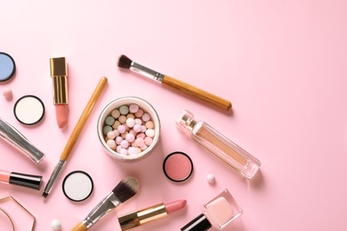 Photo of Flat lay composition with products for decorative makeup on pastel pink background