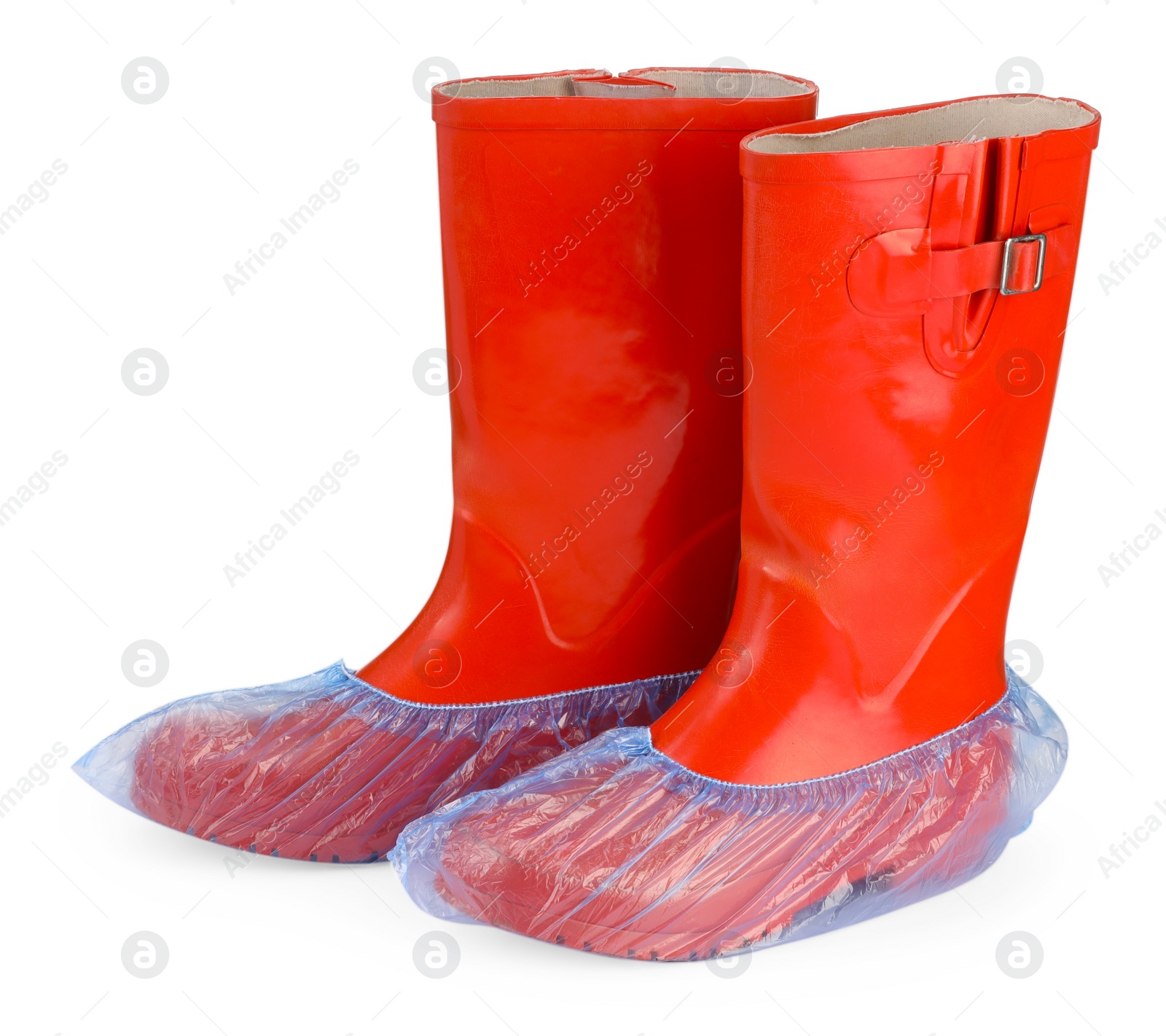 Photo of Rubber boots in blue shoe covers isolated on white