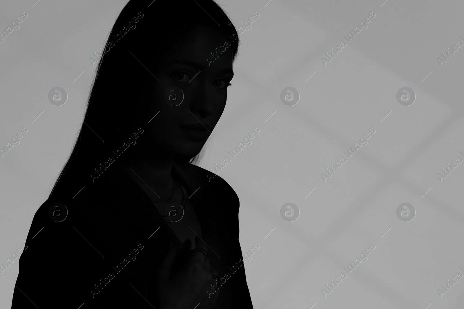 Image of Silhouette of woman on grey background, space for text