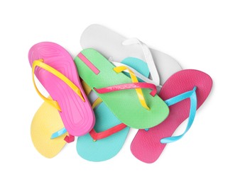 Photo of Bright flip flops on white background, top view