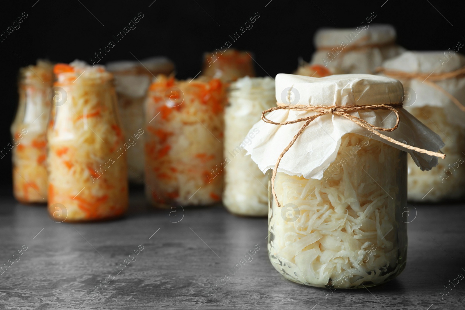 Photo of Tasty homemade fermented cabbage on grey table